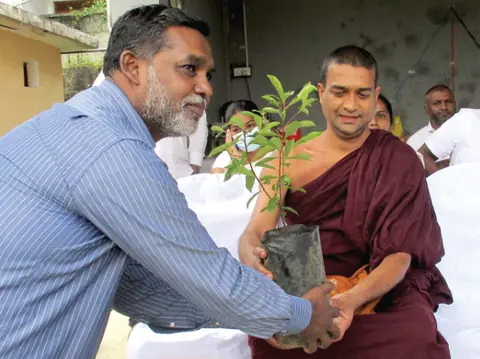 Planting a sapling with a Buddhist monk
