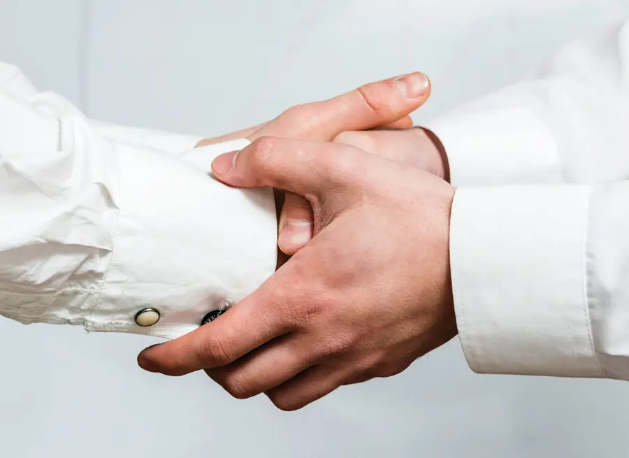 Two hands clasped together